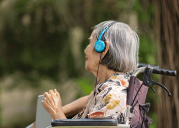 A woman with dementia listening to music as part of music therapy