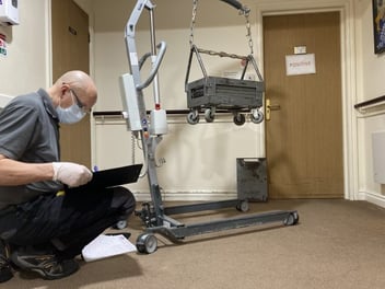 Our servicing engineer writing down the care home equipment cost. 