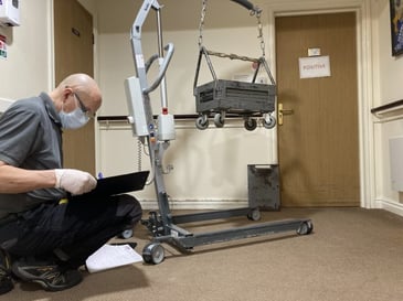 Our servicing engineer writing down the care home equipment cost. 