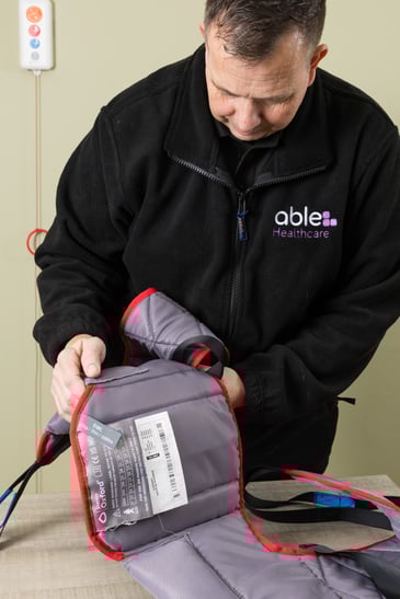 An engineer completing a toileting sling safety check.